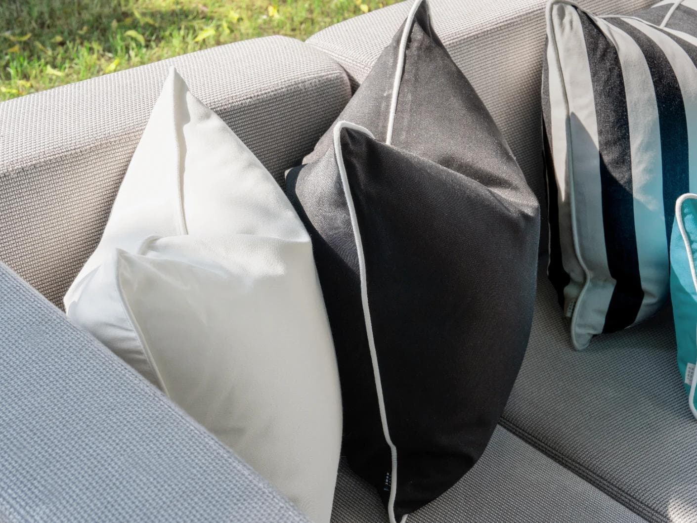 Aelius Bundle cushion in ivory, turquoise and black, shown in a lifestyle left view as image 5