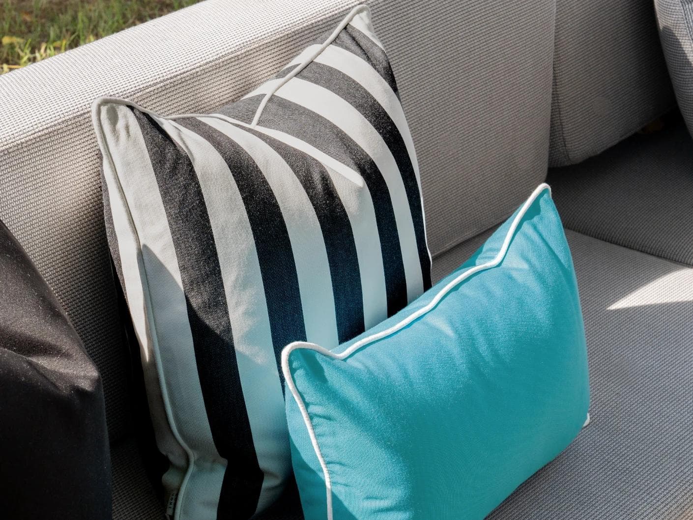 Aelius Bundle cushion in ivory, turquoise and black, shown in a lifestyle left view as image 6