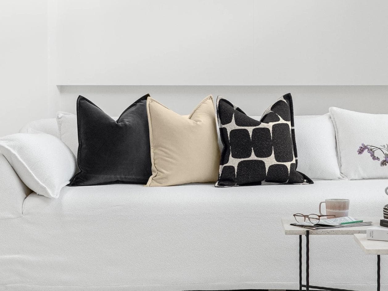 Aijan Bundle cushion in beige, grey and charcoal, shown in a lifestyle front view as image 4
