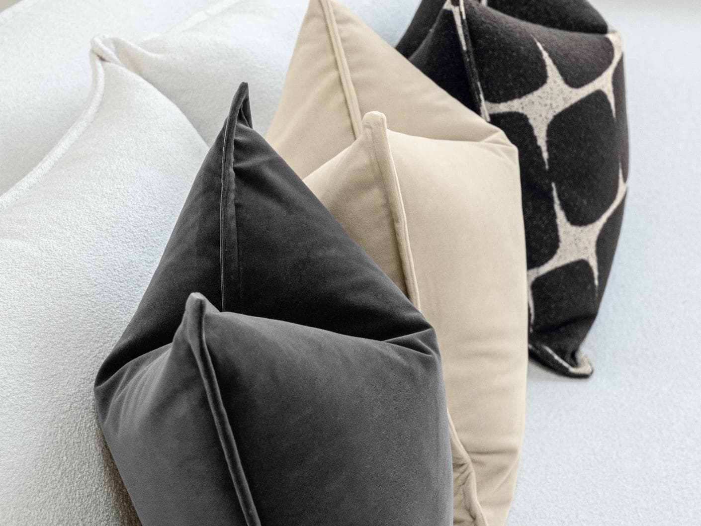 Aijan Bundle cushion in beige, grey and charcoal, shown in a lifestyle left view as image 7