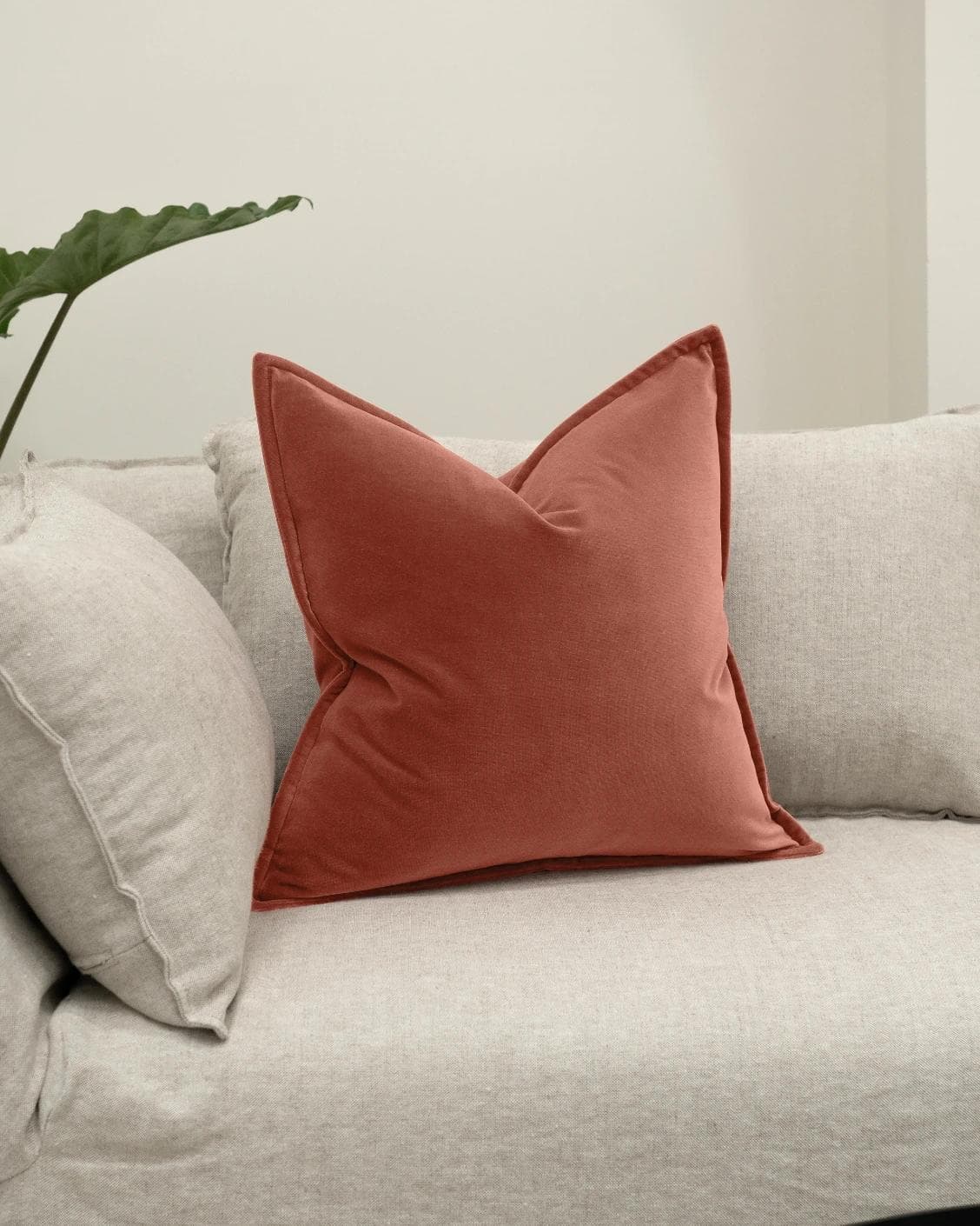 Alessandra Blush cushion in pink and red, shown in a lifestyle left view as image 2