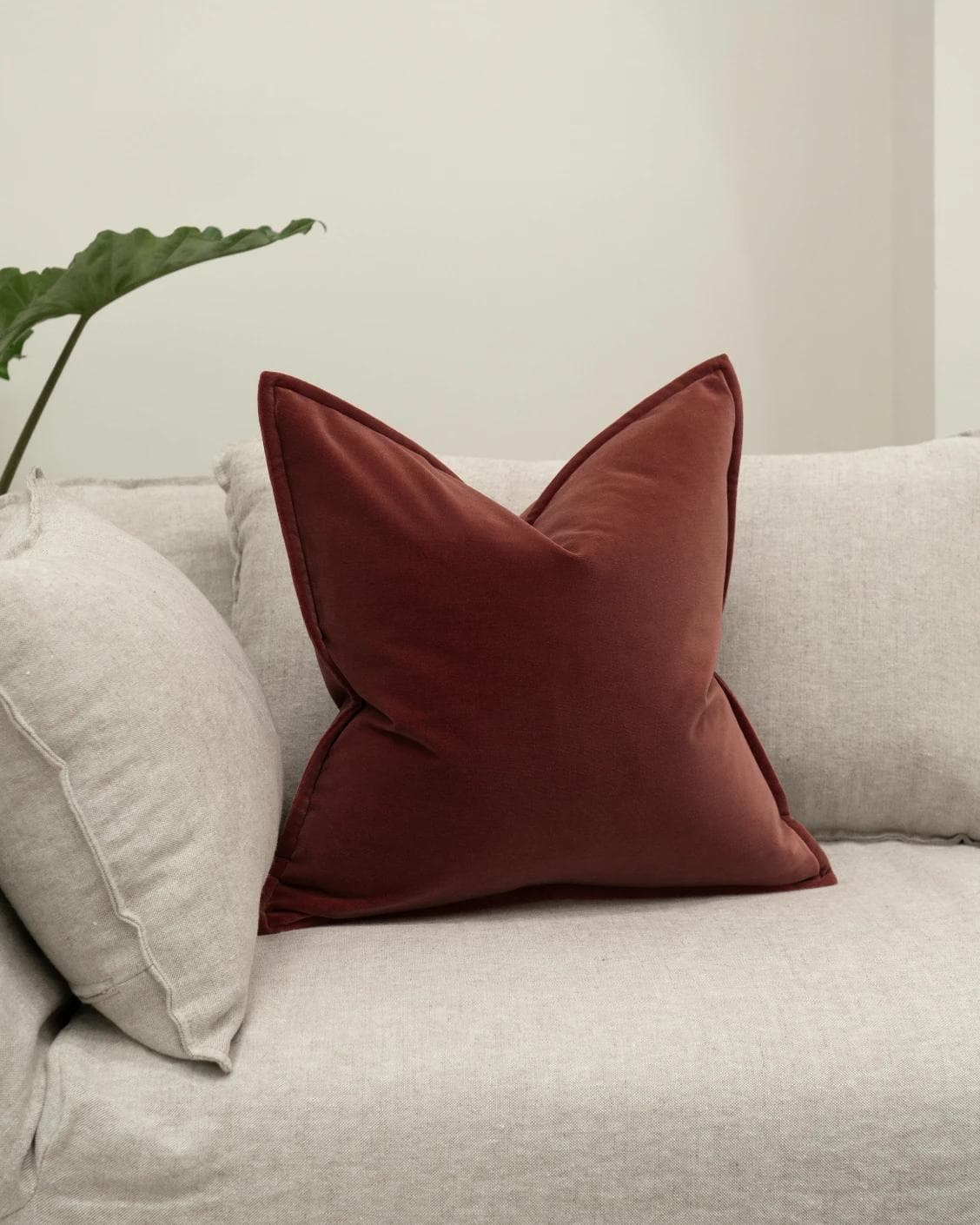 Alessandra Cherry cushion in red, shown in a lifestyle front view as image 2
