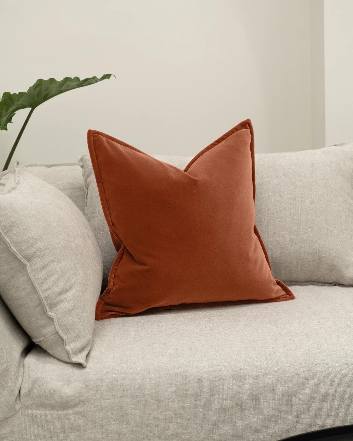 Alessandra Crimson cushion in orange, shown in a lifestyle front view as image 2