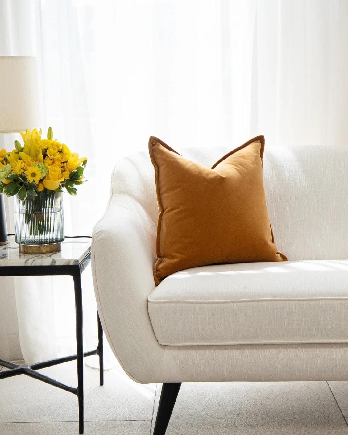 Alessandra Hodler cushion in orange, shown in a lifestyle front view as image 4