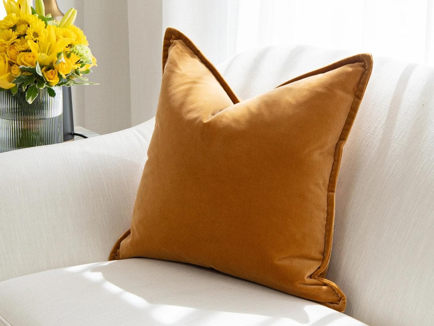 Alessandra Hodler cushion in orange, shown in a lifestyle top view as image 2