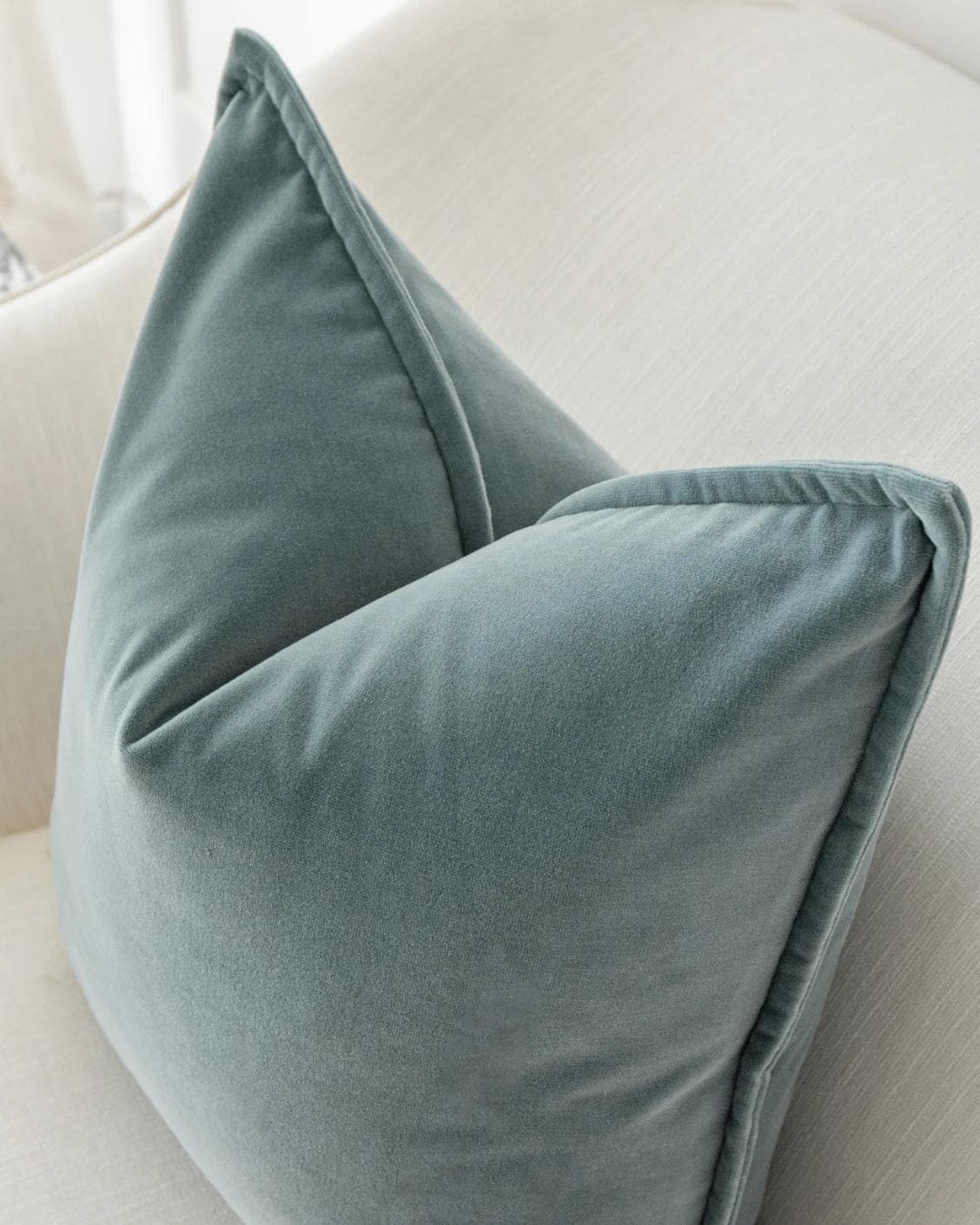 Alessandra Lucas cushion in pastel blue and blue, shown in a lifestyle top view as image 5