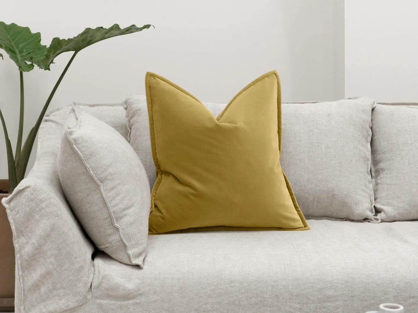 Alessandra Moss cushion in gold, shown in a lifestyle front view as image 4