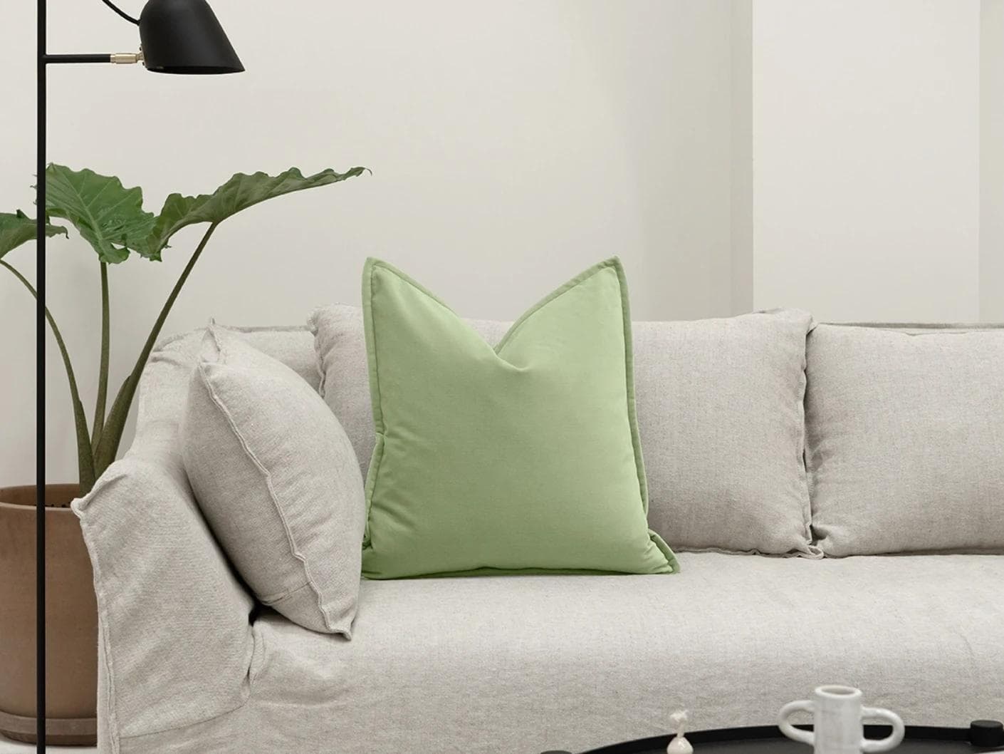 Alessandra Pistachio cushion in green, shown in a lifestyle front view as image 4