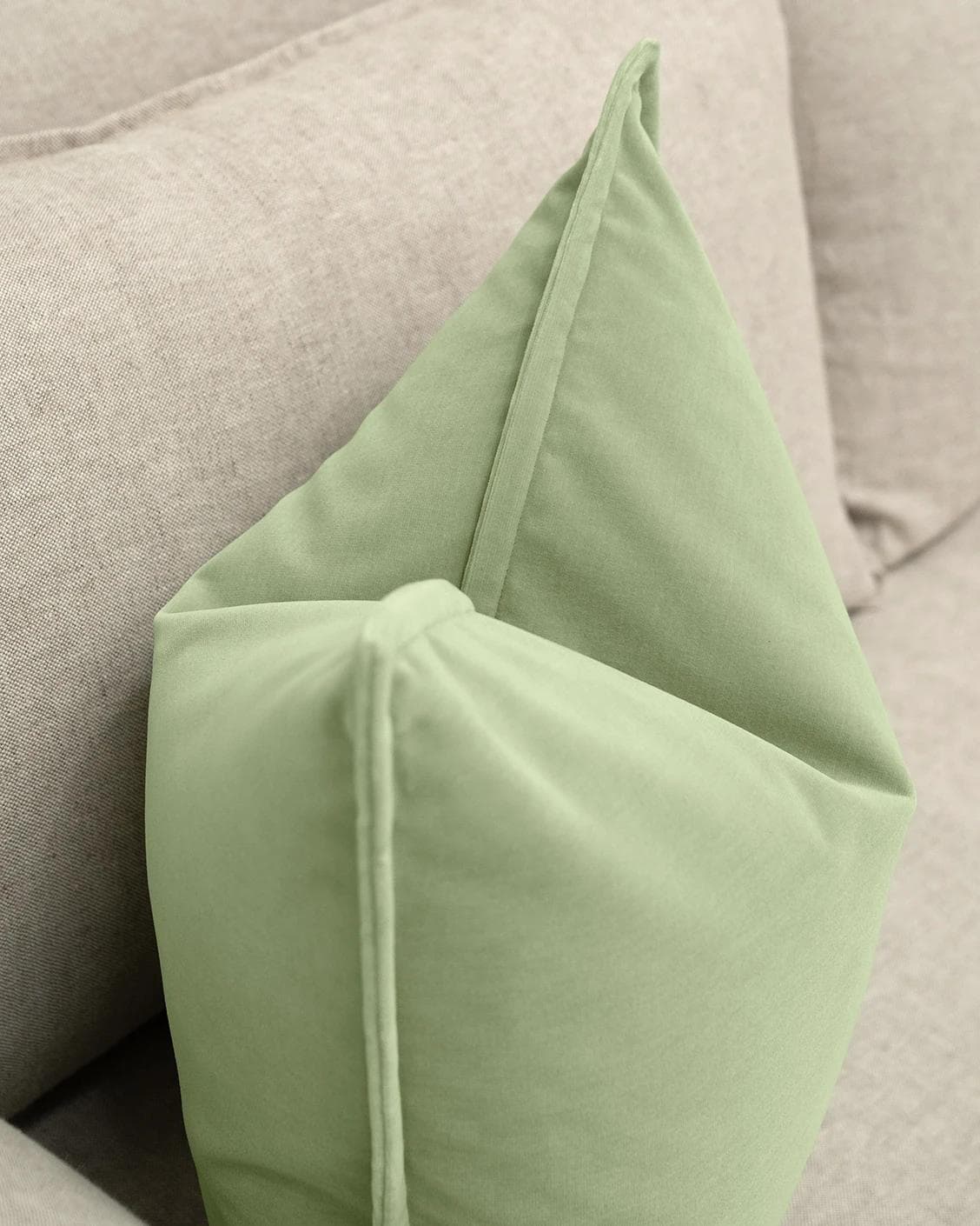 Alessandra Pistachio cushion in green, shown in a lifestyle left view as image 5