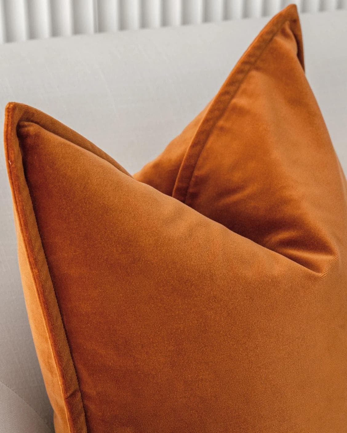Alessandra Rust cushion in orange, shown in a lifestyle close-up as image 4