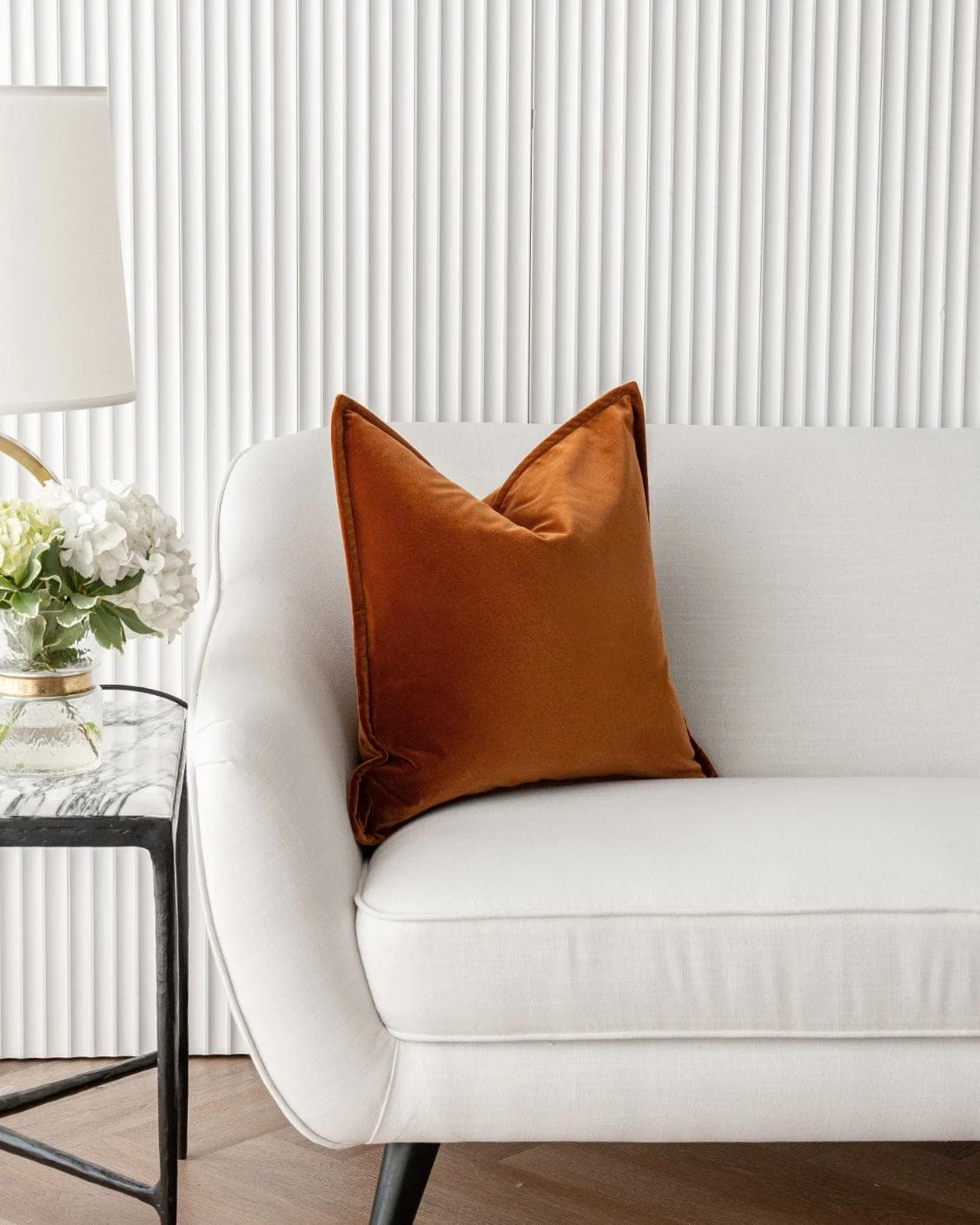 Alessandra Rust cushion in orange, shown in a lifestyle front view as image 1