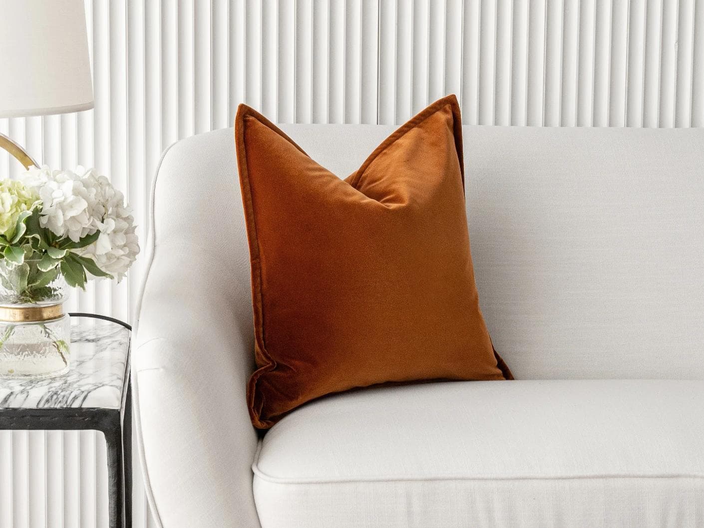Alessandra Rust cushion in orange, shown in a lifestyle front view as image 1