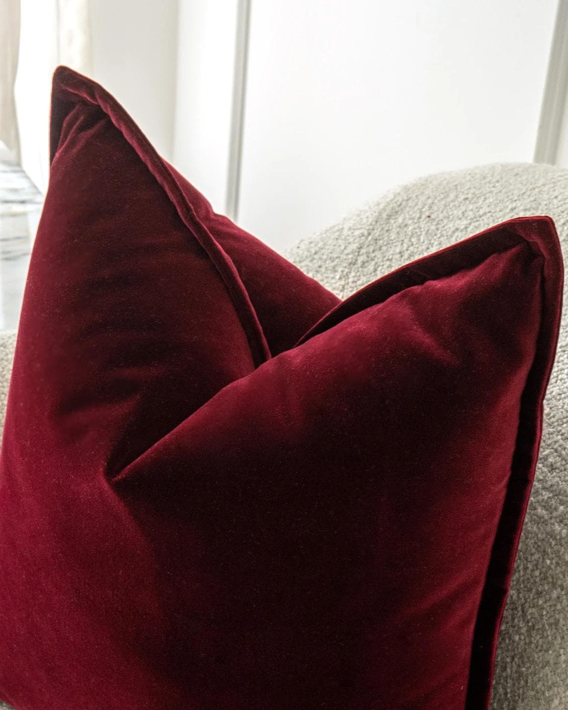 Alessandra Scarlet cushion in red, shown in a lifestyle top view as image 5