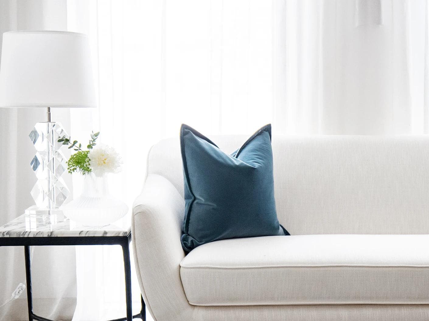 Alessandra Sky cushion in blue, shown in a lifestyle front view as image 1