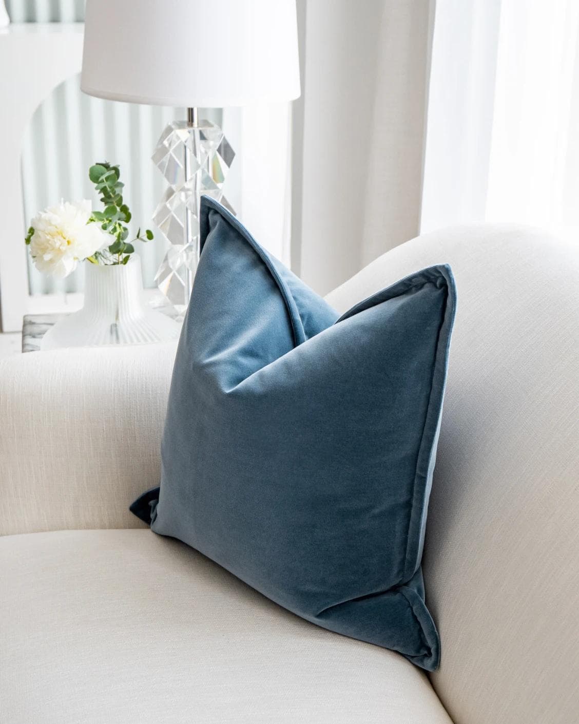 Alessandra Sky cushion in blue, shown in a lifestyle left view as image 5