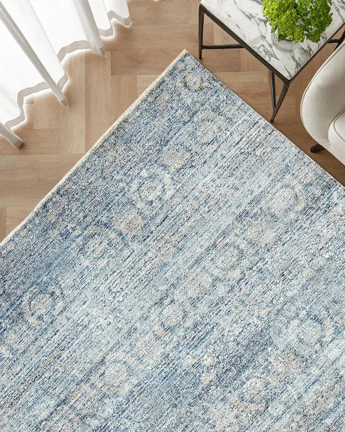 Alexander Azure carpet in blue, shown in a lifestyle top view as image 2