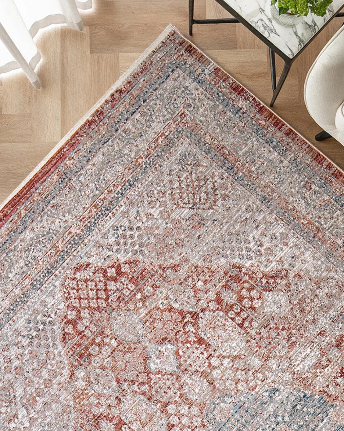 Alexander Rosso carpet in red and beige, shown in a lifestyle top view as image 2