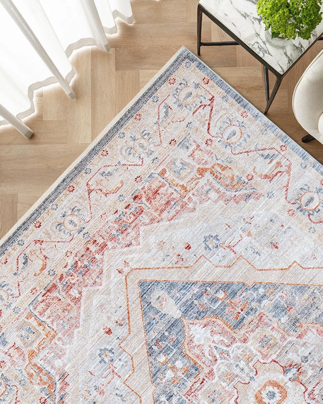 Alexander Rouge carpet in beige, blue and red, shown in a lifestyle top view as image 2