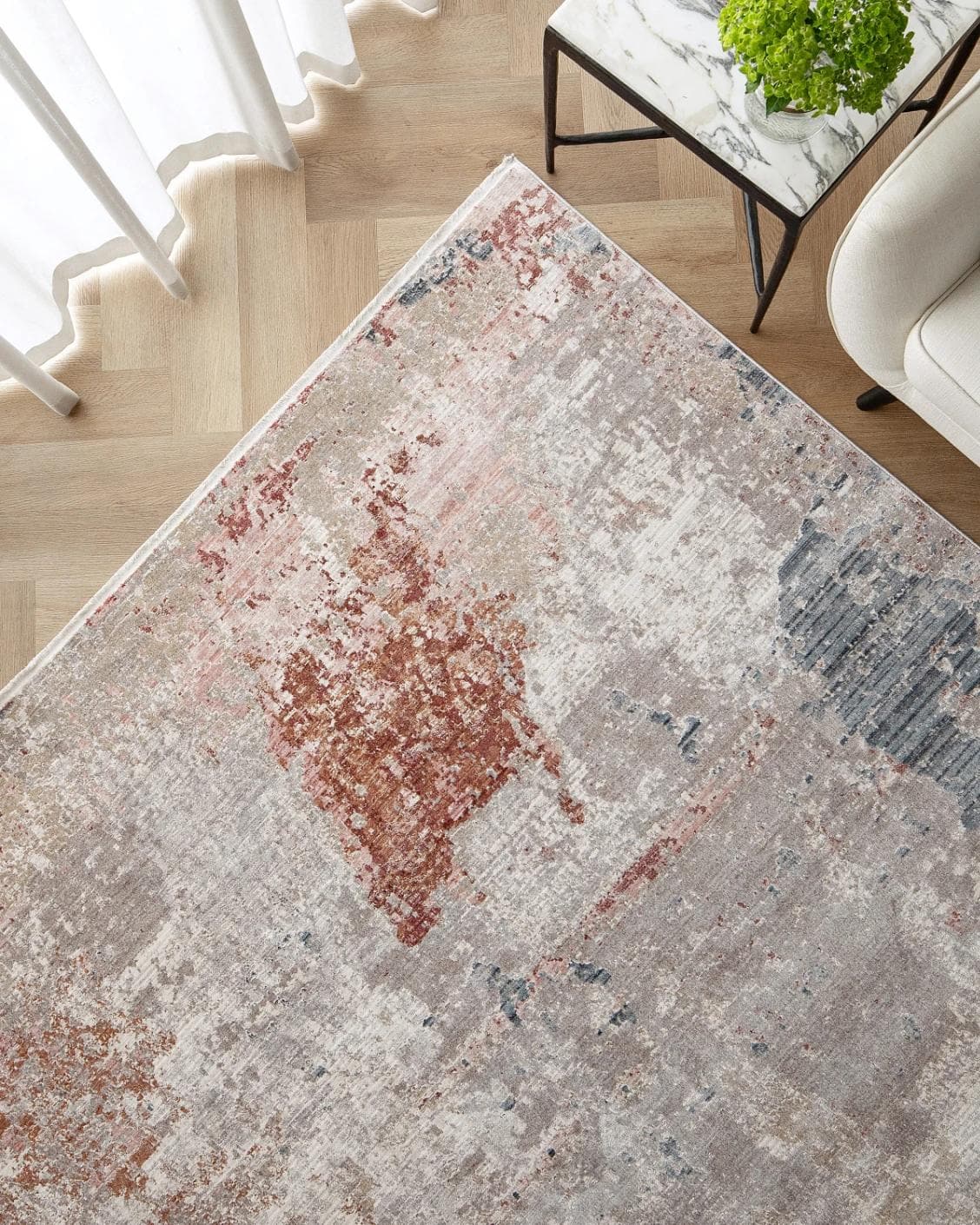 Alexander Russell carpet in beige, rust and blue, shown in a lifestyle top view as image 2