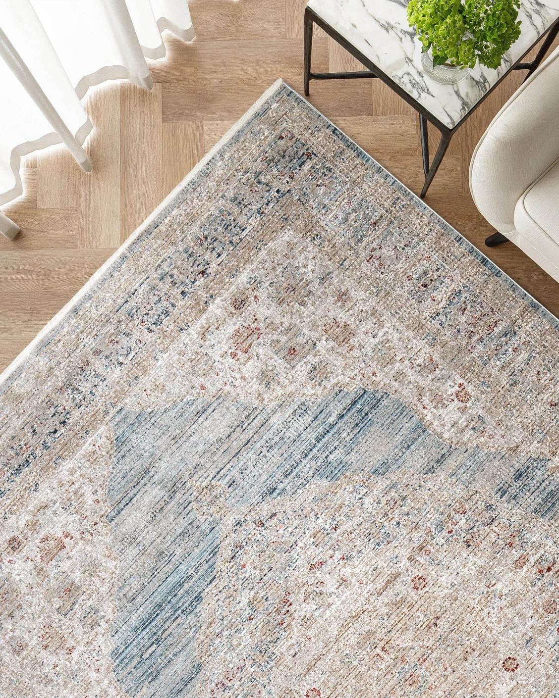 Alexander Sky carpet in pale blue, blue and beige, shown in a lifestyle top view as image 2