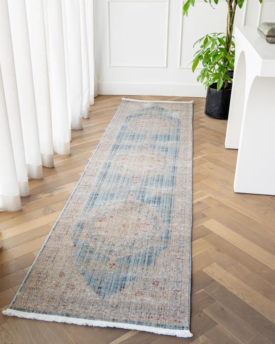 Alexander Sky Runners carpet in pale blue, blue and beige, shown in a product front view