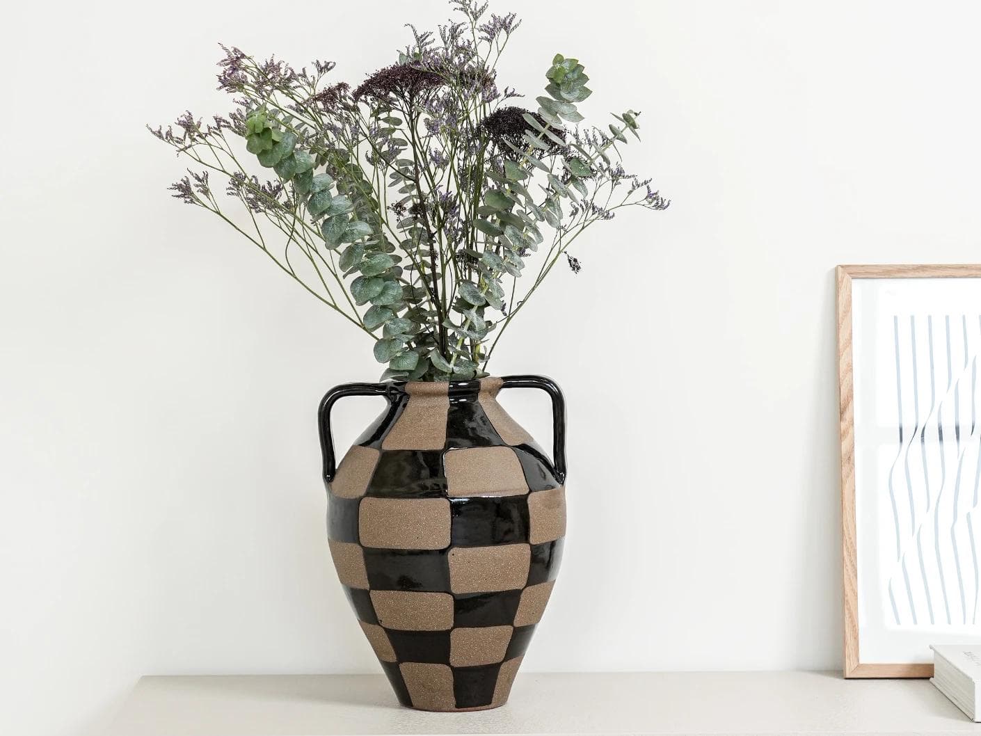 Alisca Terra vases in charcoal black, warm clay, brown and black, shown in a lifestyle front view as image 2
