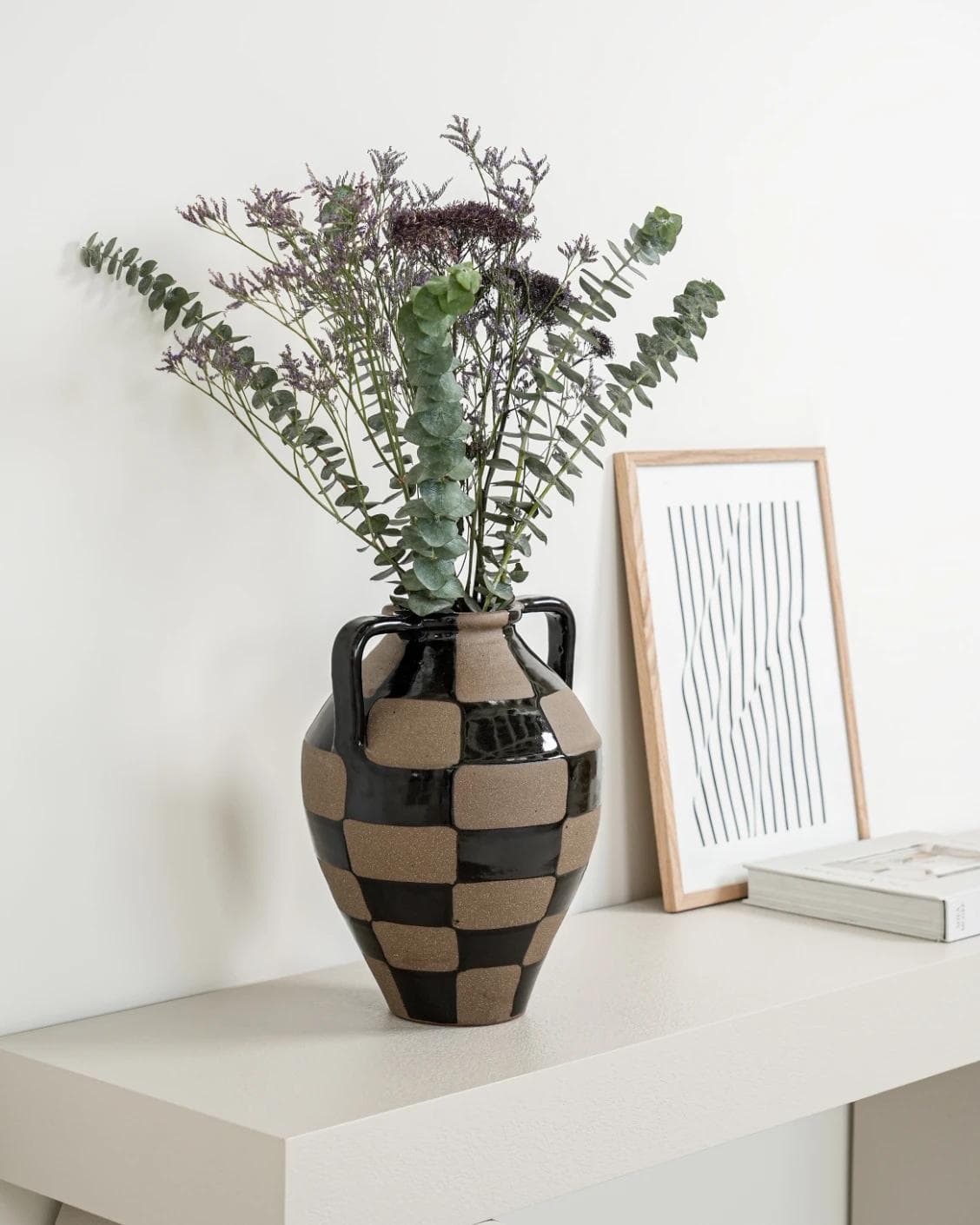Alisca Terra vases in charcoal black, warm clay, brown and black, shown in a lifestyle left view as image 4