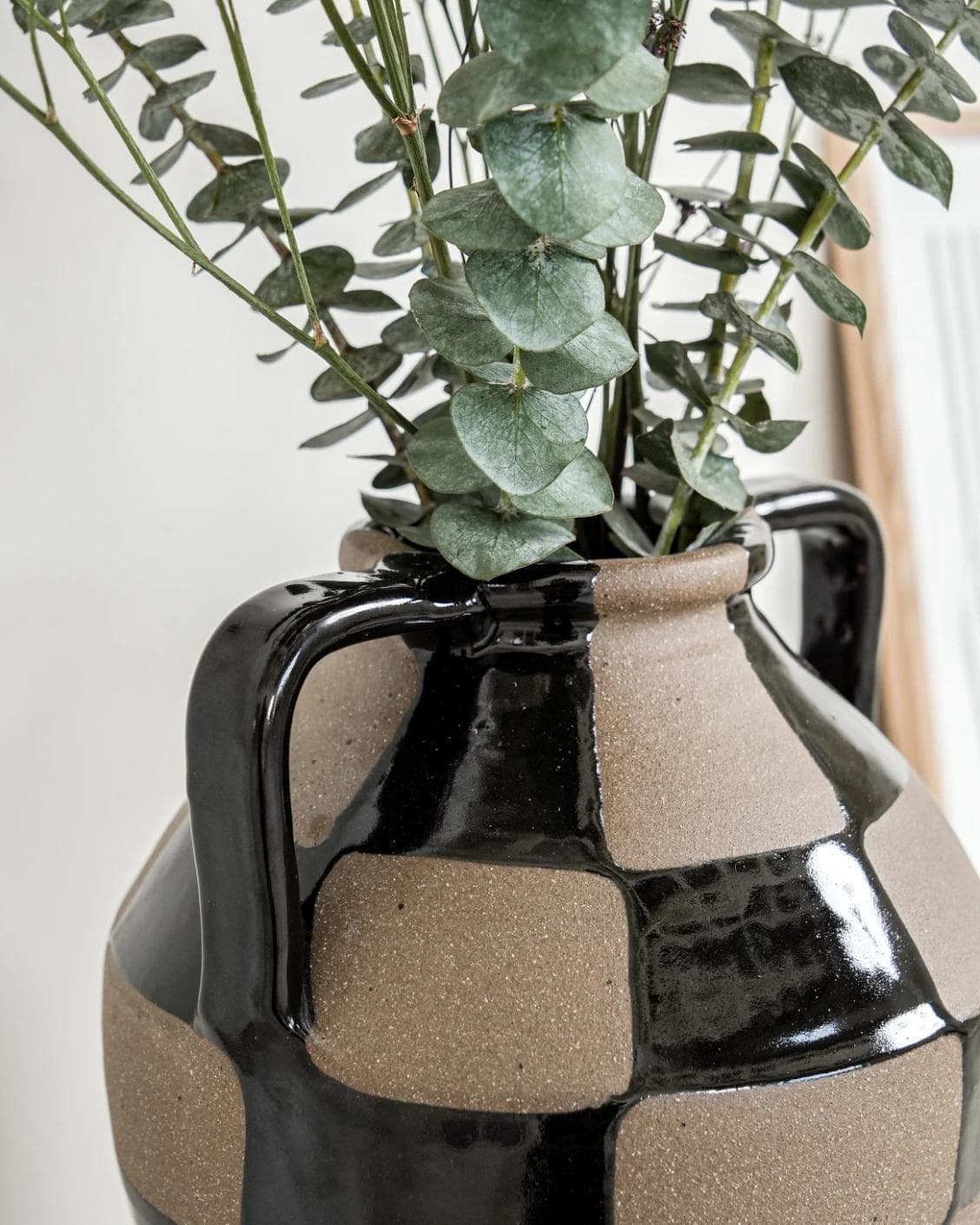 Alisca Terra vases in charcoal black, warm clay, brown and black, shown in a lifestyle left view as image 5