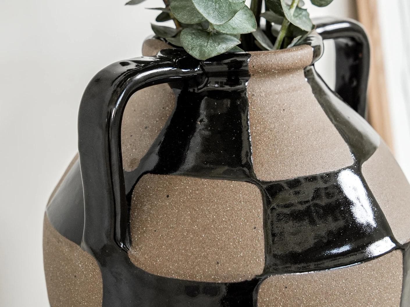 Alisca Terra vases in charcoal black, warm clay, brown and black, shown in a lifestyle left view as image 5
