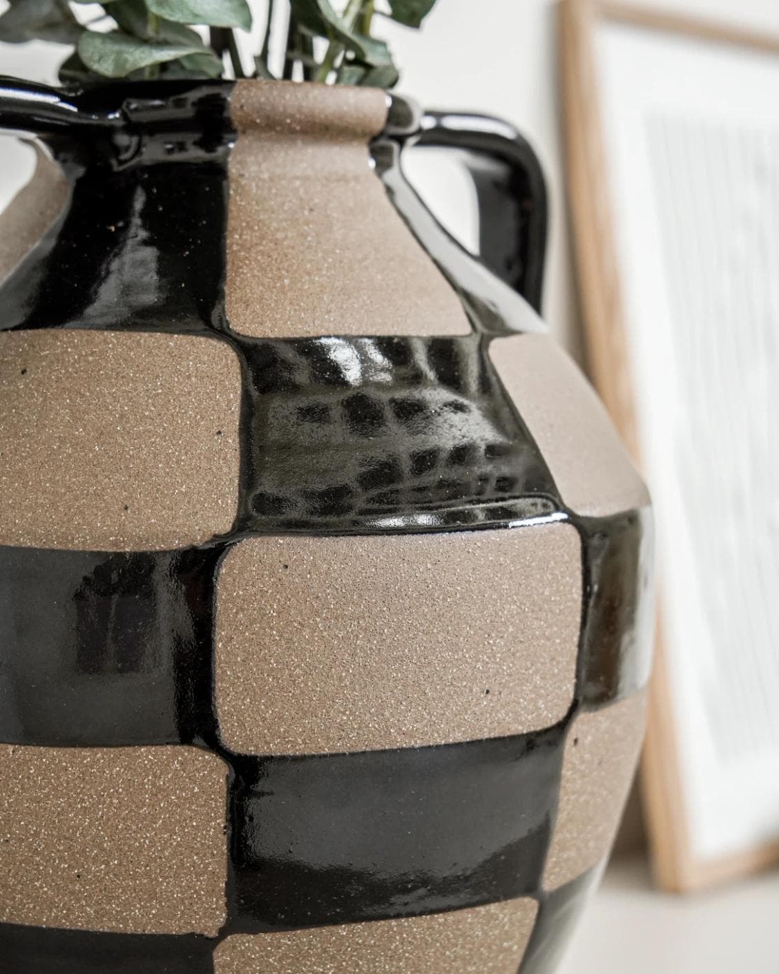 Alisca Terra vases in charcoal black, warm clay, brown and black, shown in a lifestyle left view as image 6