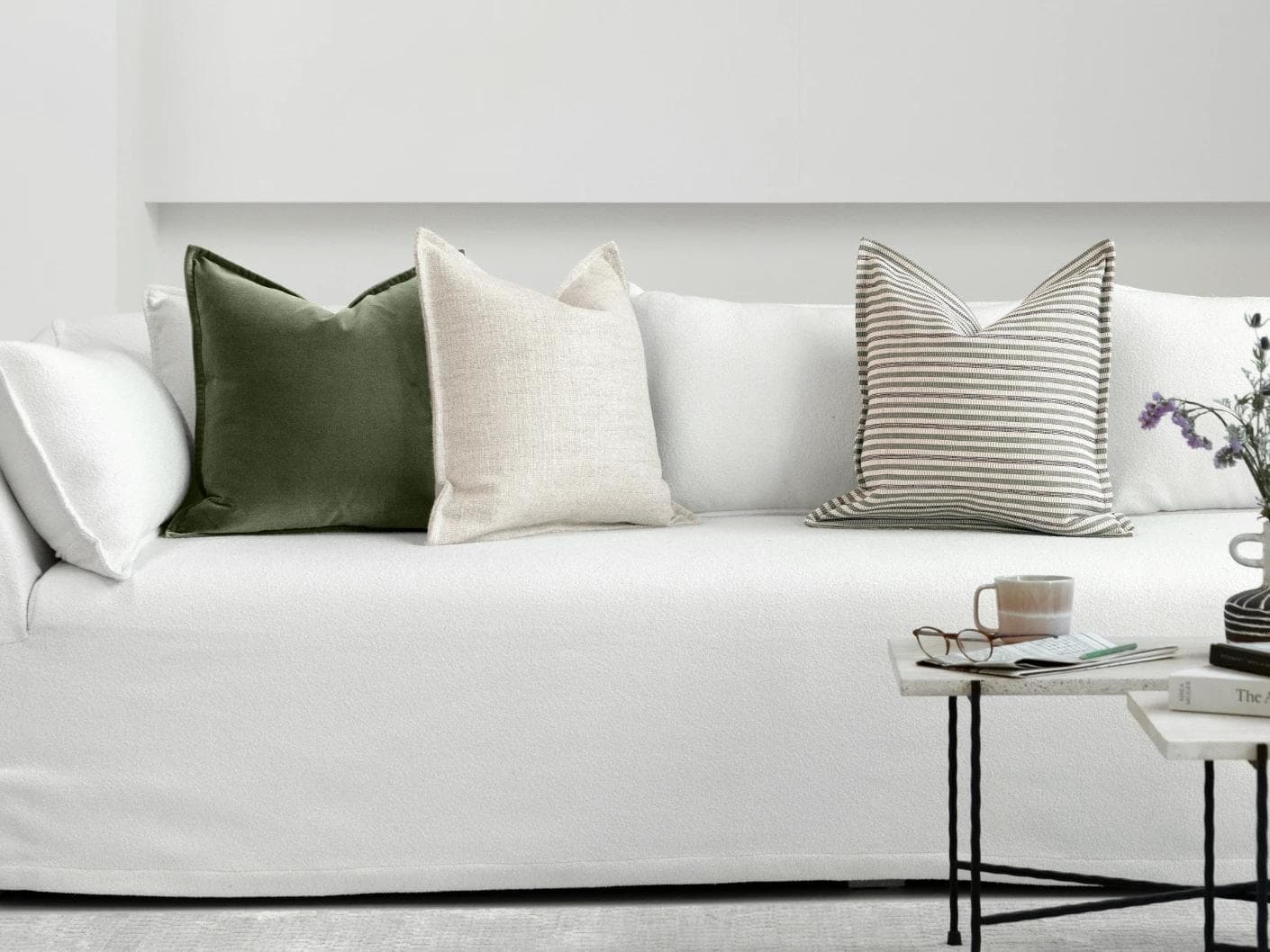 Aliva Bundle cushion in ivory, green and off white, shown in a lifestyle front view as image 4