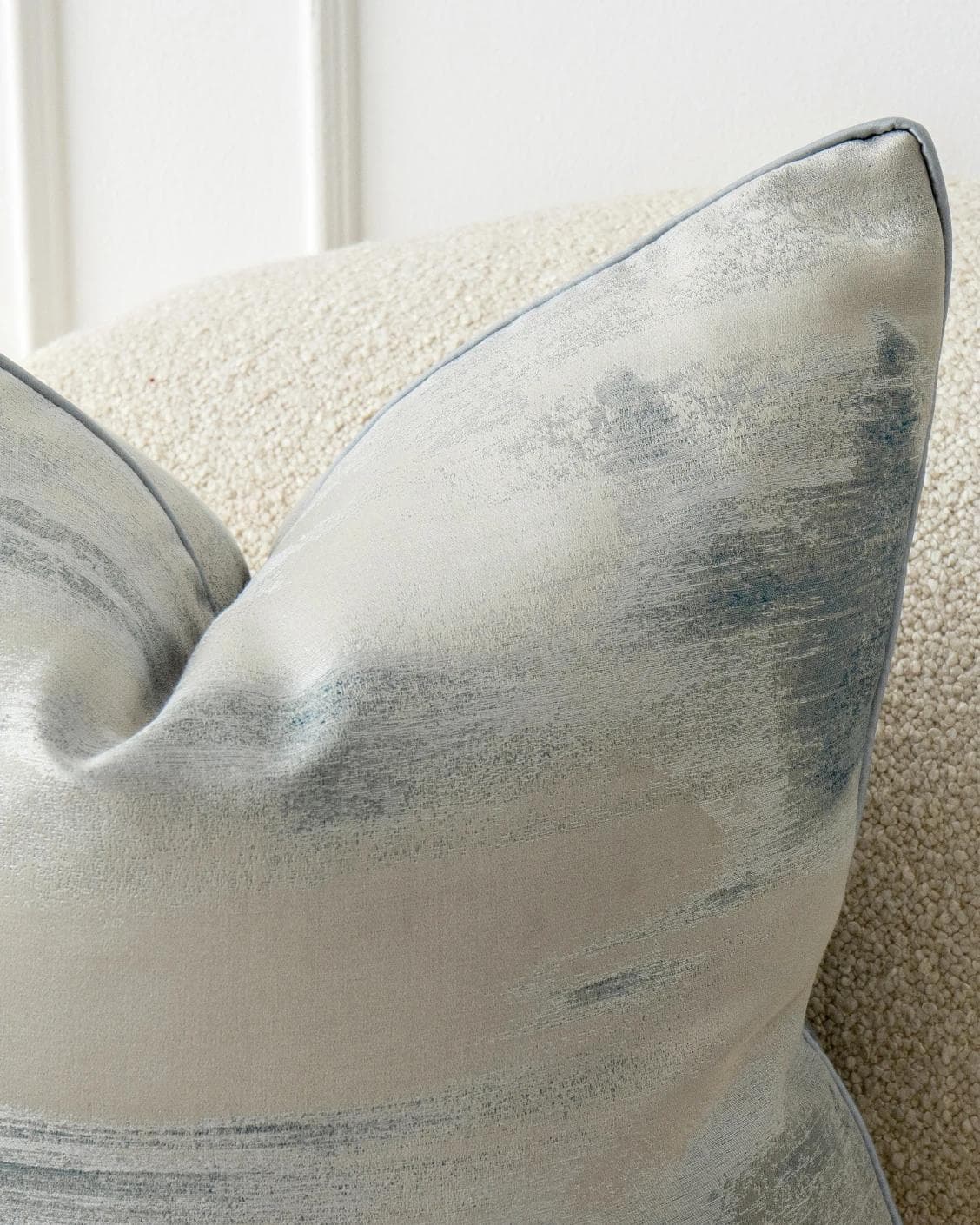 Alma Canova cushion in blue and silver, shown in a lifestyle front view as image 5