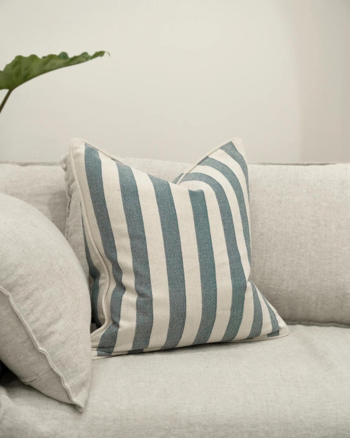 Ameline Canova cushion in blue, shown in a lifestyle front view as image 2