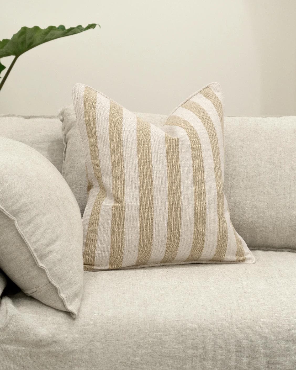 Ameline Klimt cushion in beige, shown in a lifestyle front view as image 2