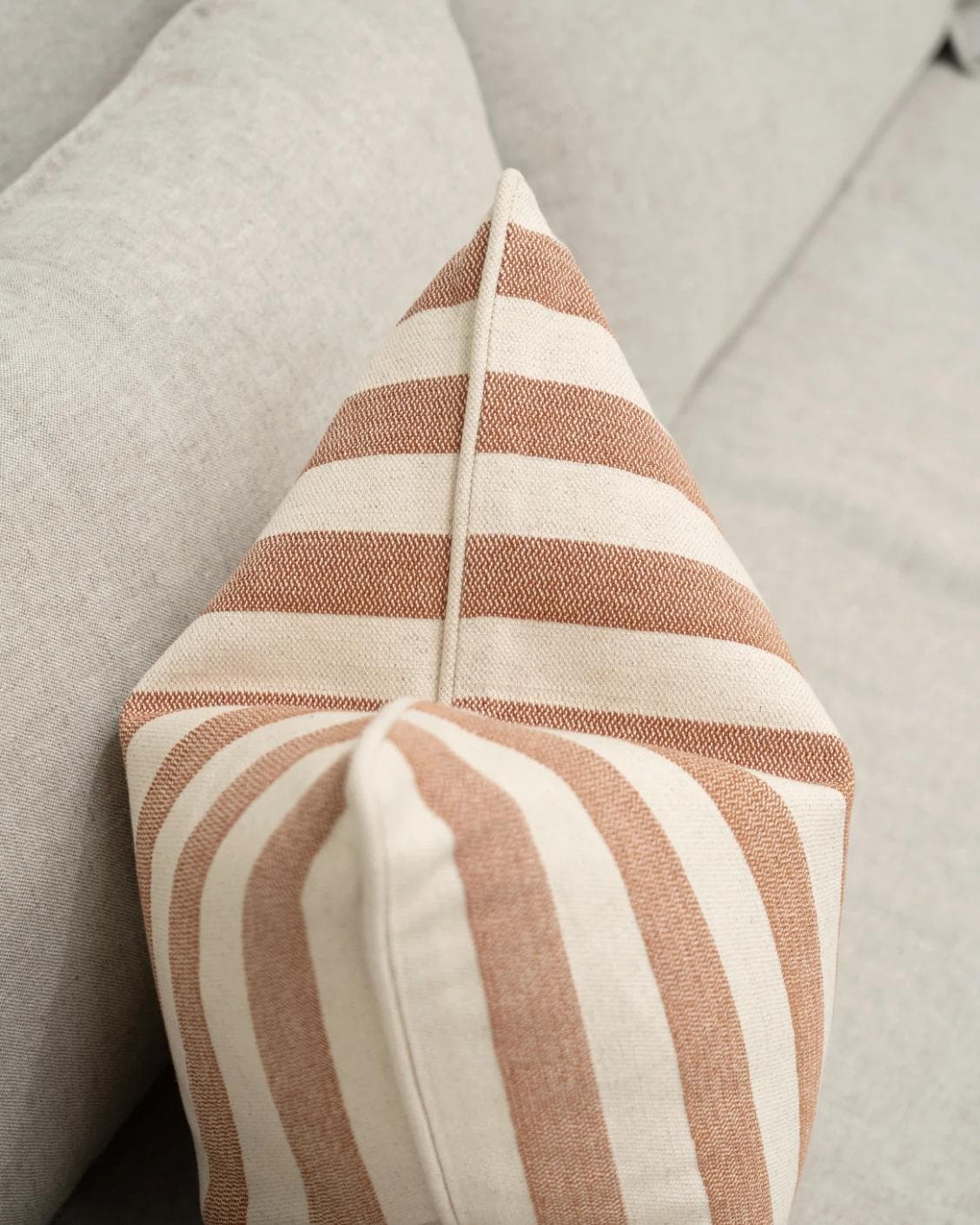 Ameline Rust cushion, shown in a lifestyle top view as image 6