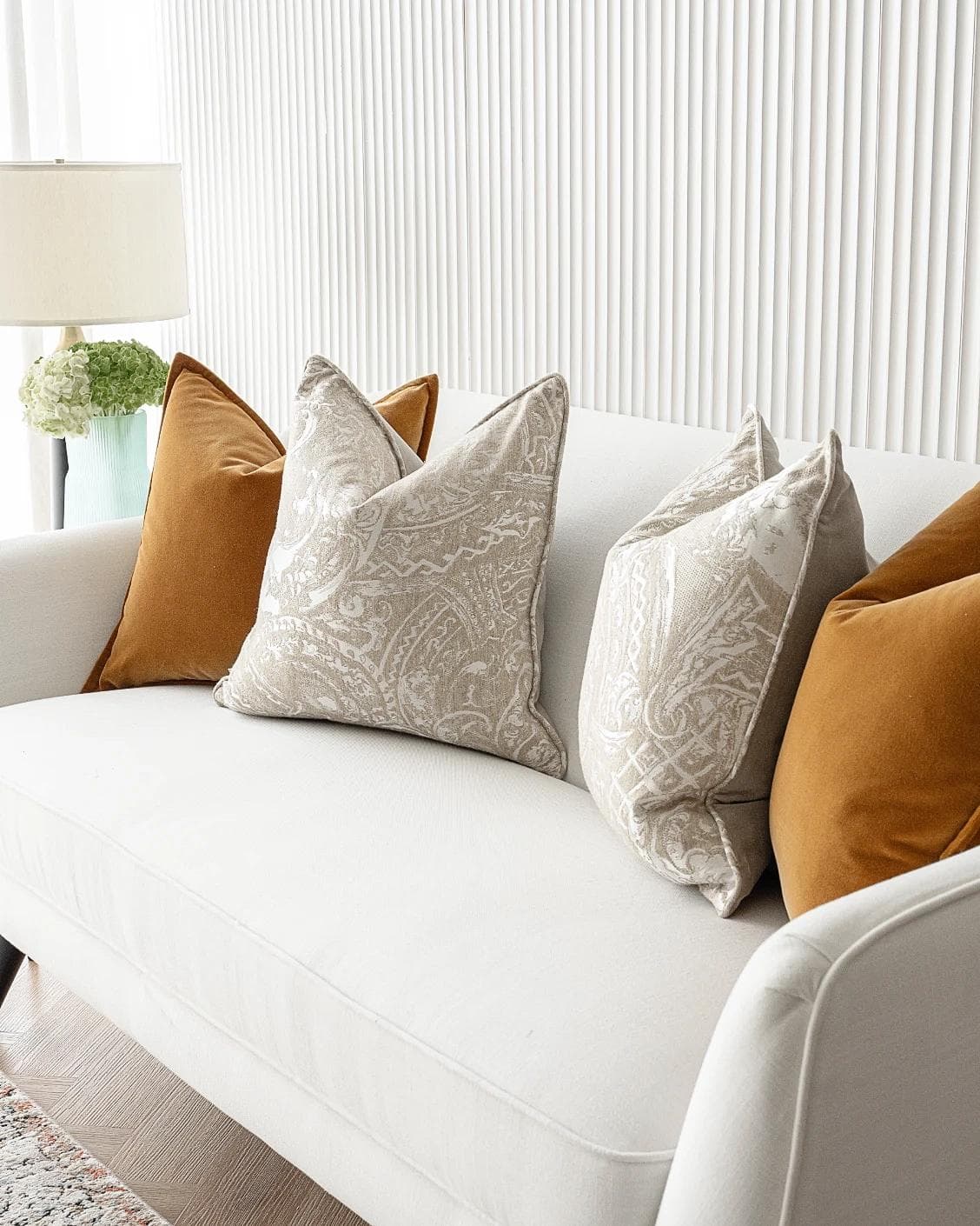 Amiya Bundle cushion in orange, beige and silver, shown in a lifestyle right view as image 5