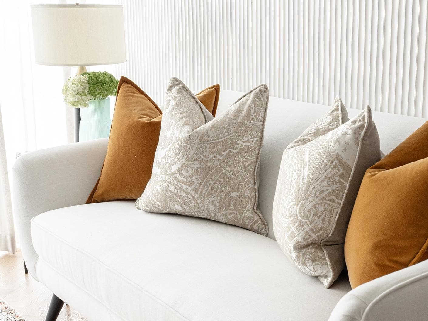 Amiya Bundle cushion in orange, beige and silver, shown in a lifestyle right view as image 5