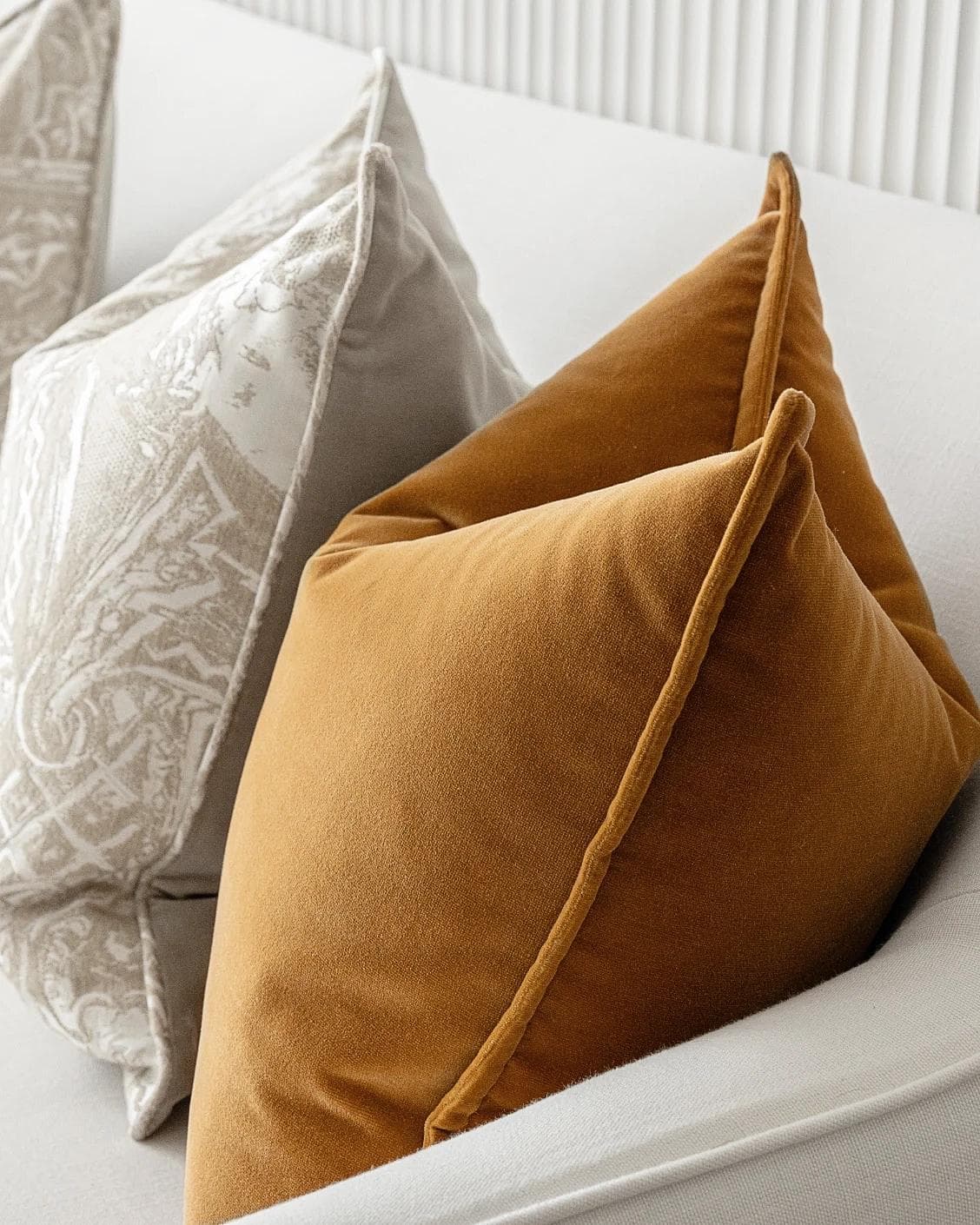 Amiya Bundle cushion in orange, beige and silver, shown in a lifestyle right view as image 6
