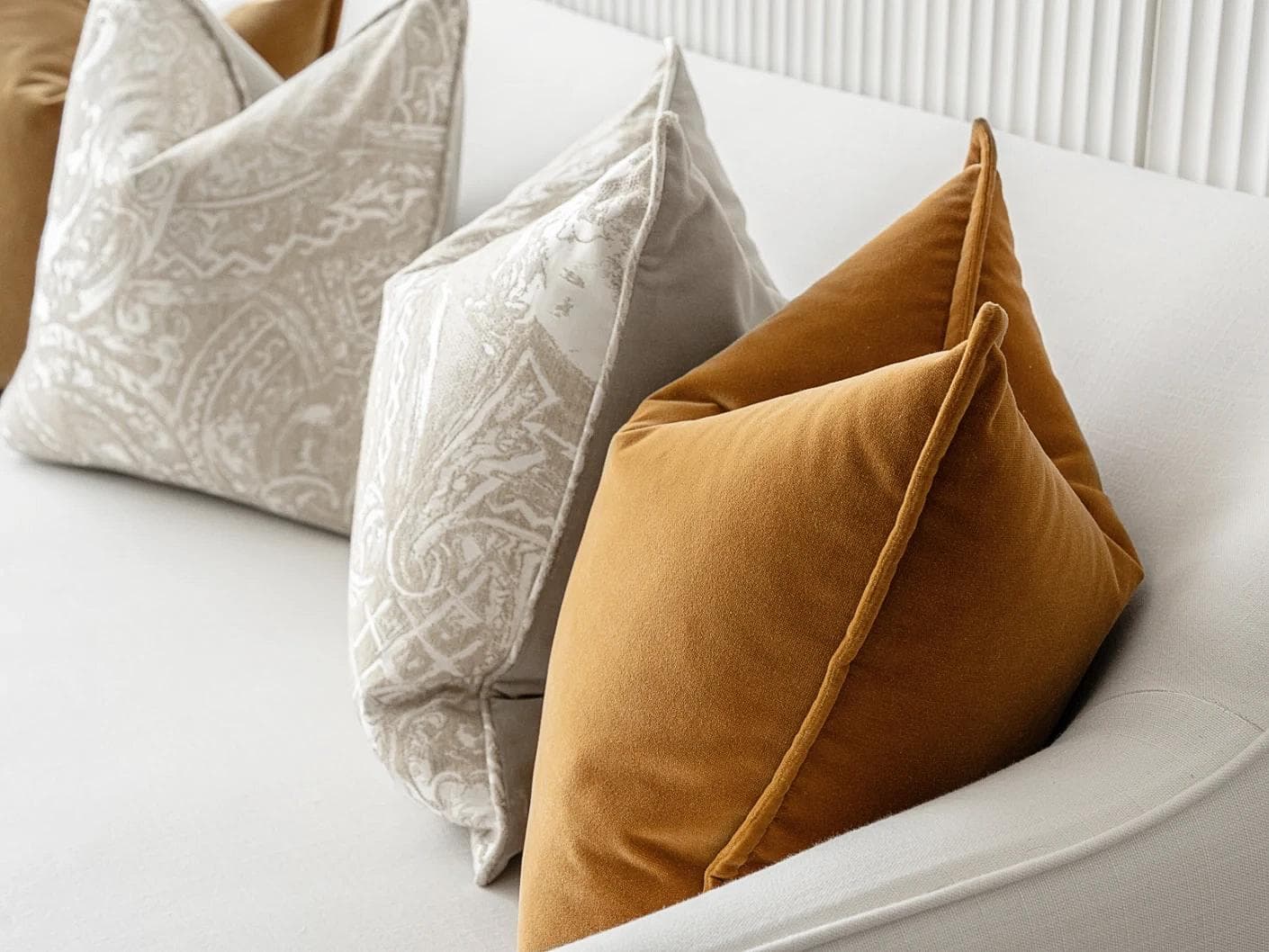 Amiya Bundle cushion in orange, beige and silver, shown in a lifestyle right view as image 6