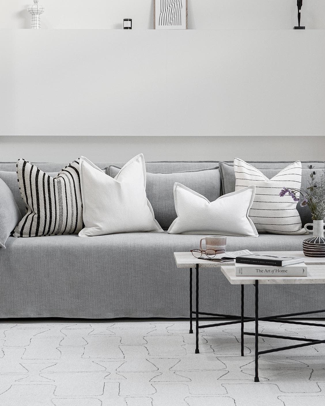 Amshi Bundle cushion in ivory, white and charcoal, shown in a lifestyle front view as image 4