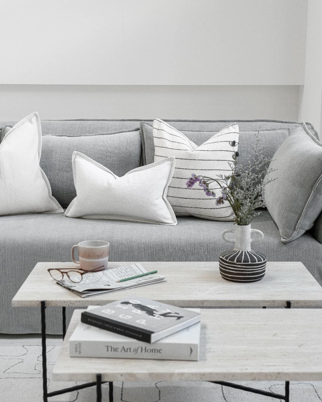 Amshi Bundle cushion in ivory, white and charcoal, shown in a lifestyle front view as image 5