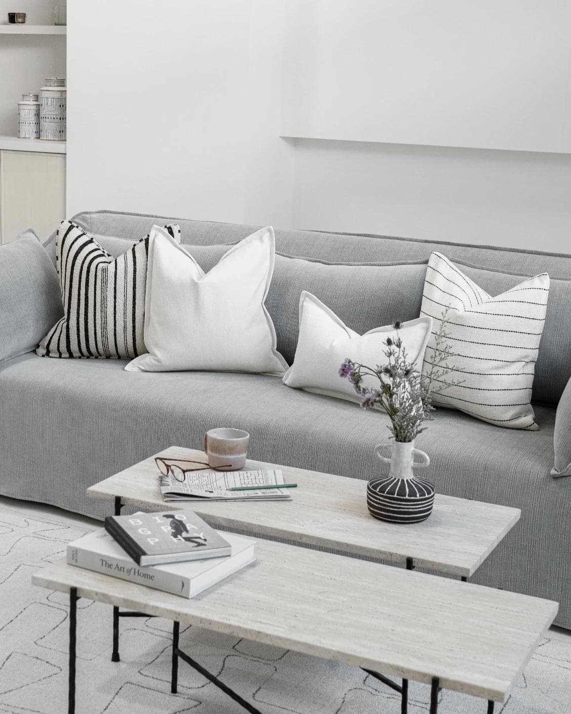 Amshi Bundle cushion in ivory, white and charcoal, shown in a lifestyle top view as image 2