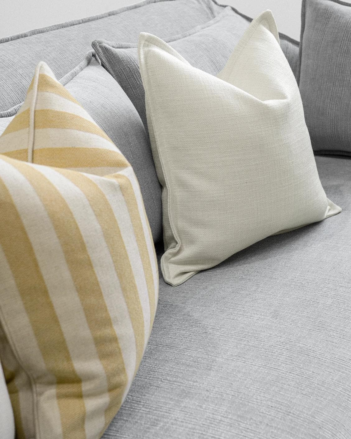 Ansh Bundle cushion in yellow and white, shown in a lifestyle left view as image 6