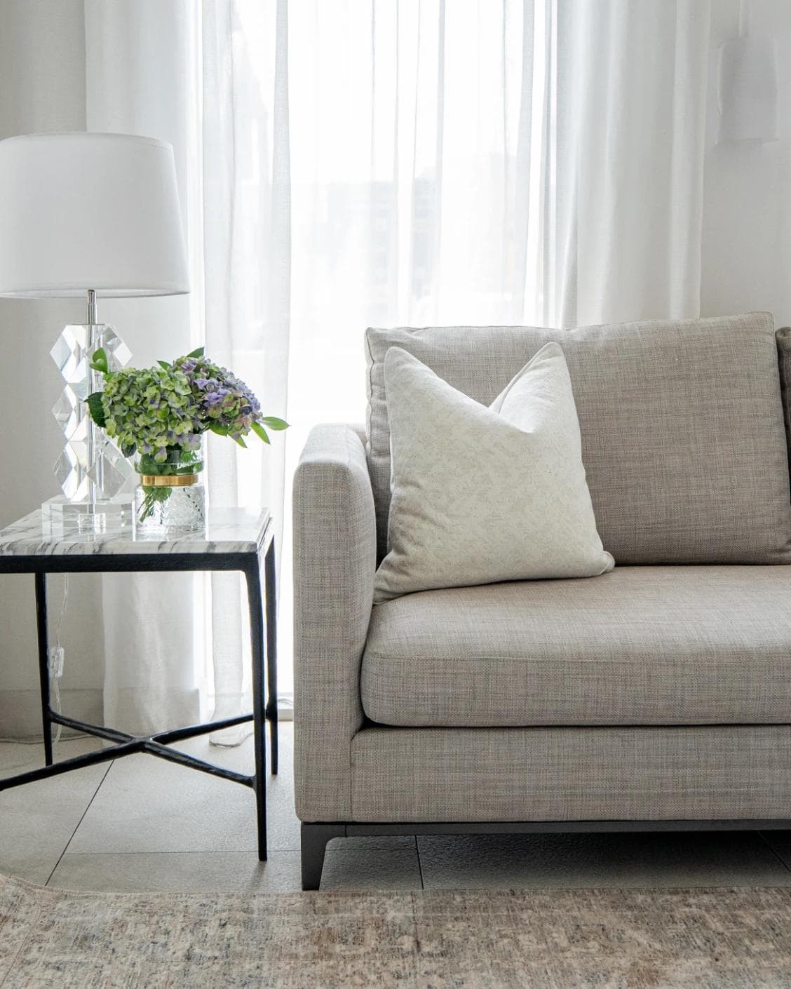 Arcie Bianca cushion in white, shown in a lifestyle front view as image 4