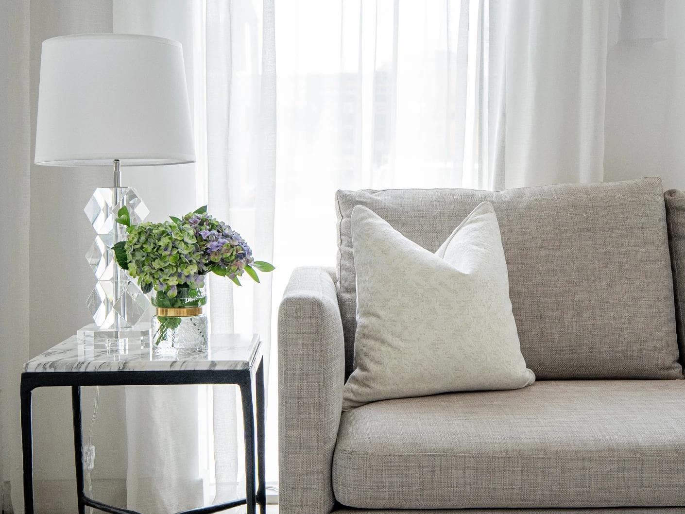 Arcie Bianca cushion in white, shown in a lifestyle front view as image 4