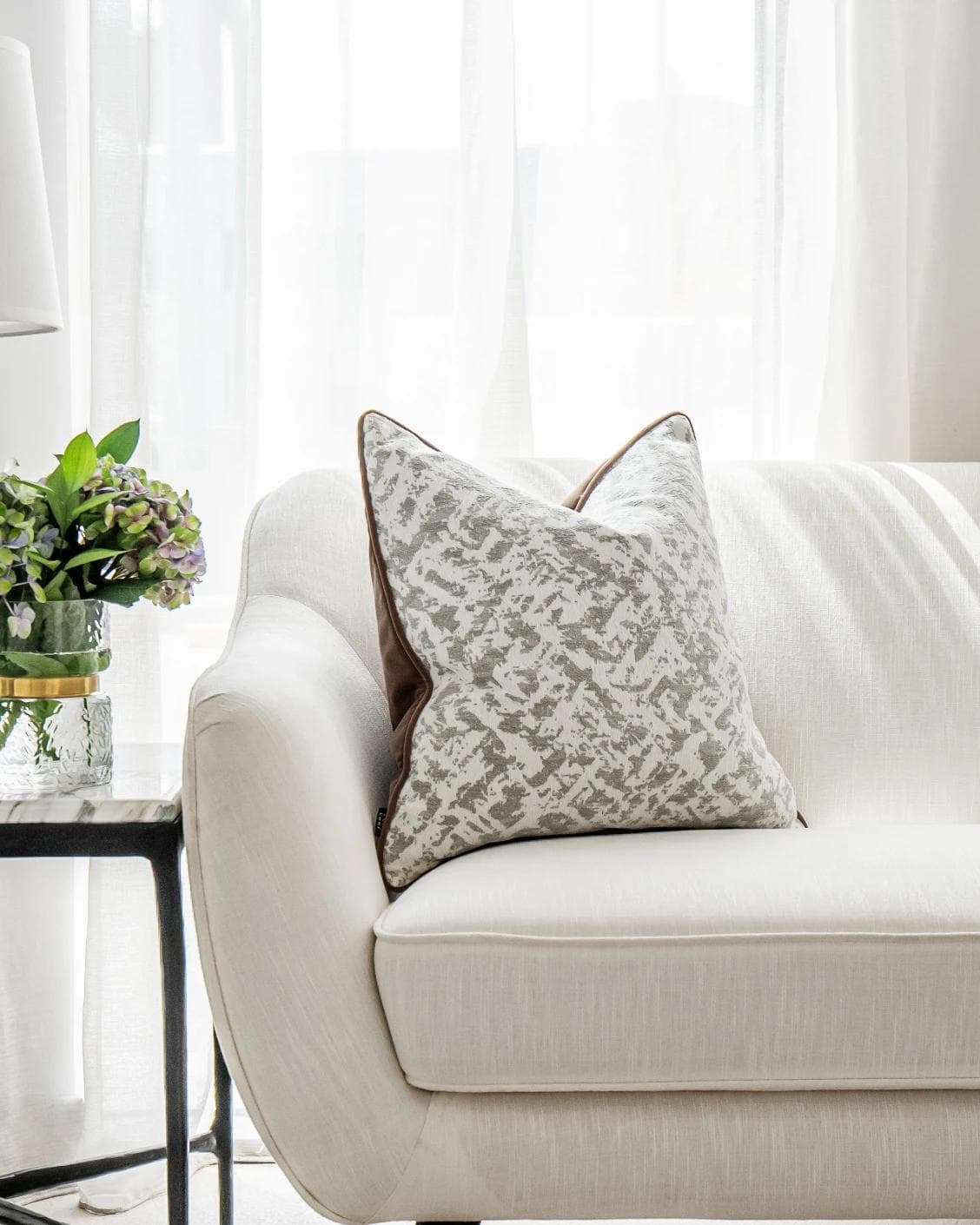 Arcie Laurent cushion in white and silver, shown in a lifestyle front view as image 4