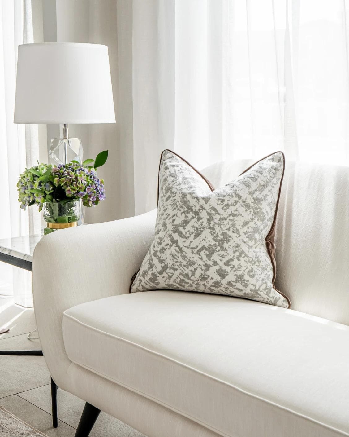 Arcie Laurent cushion in white and silver, shown in a lifestyle front view as image 2