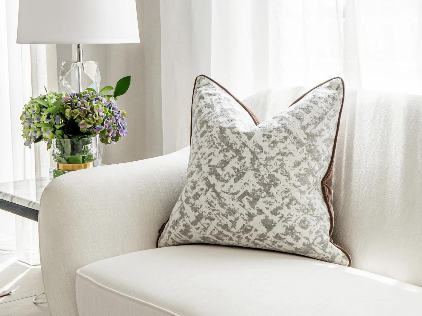 Arcie Laurent cushion in white and silver, shown in a lifestyle front view as image 2