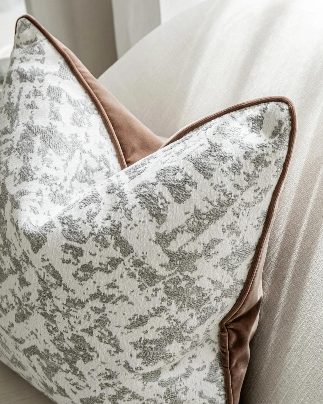 Arcie Laurent cushion in white and silver, shown in a lifestyle top view as image 7