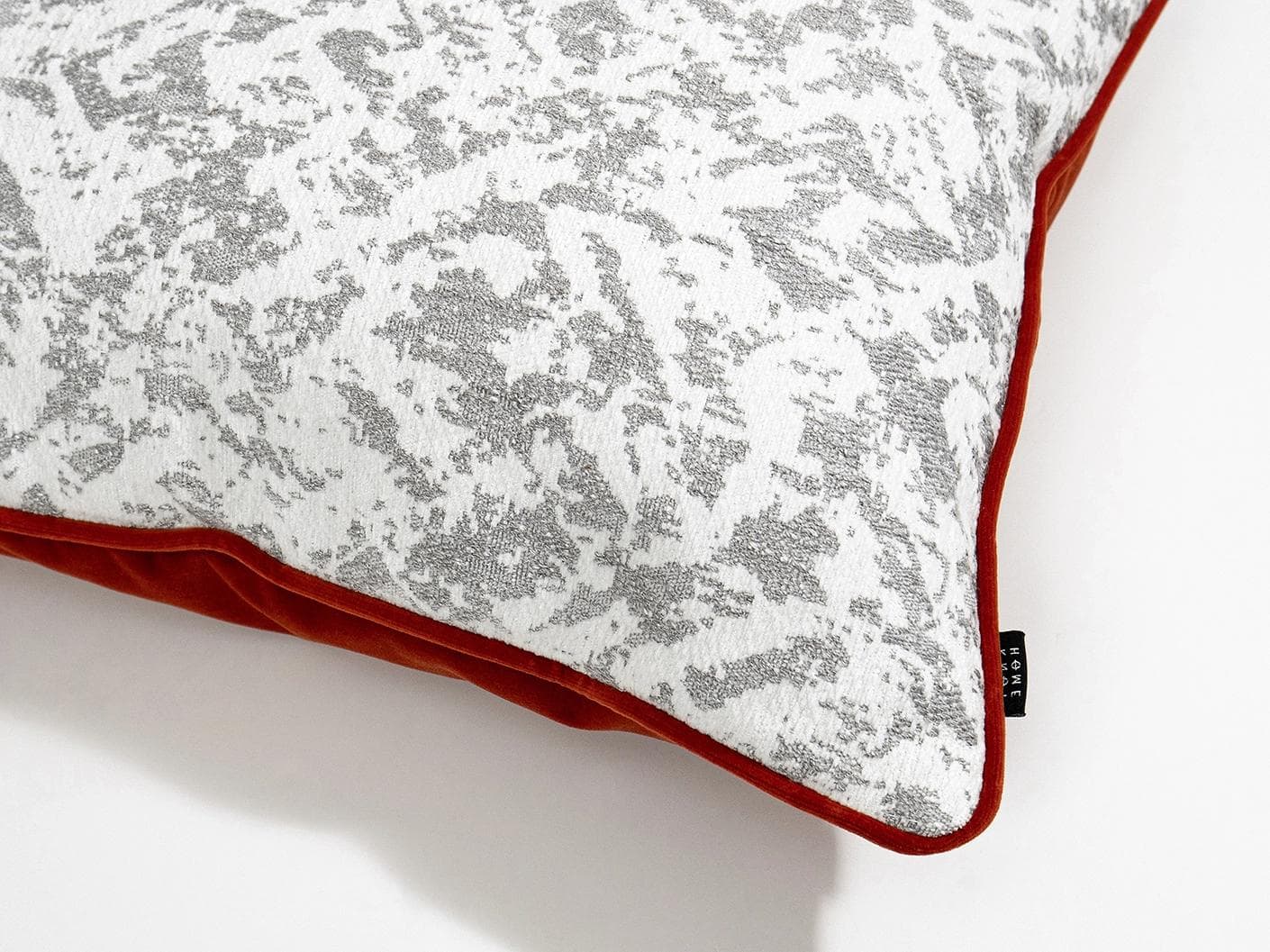 Arcie Tangelo cushion in white, grey and orange, shown in a product close-up top view as image 2